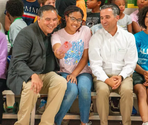 Mayor Andrew Ginther poses for a photo with a Summer Teen Experience participant and CEO Tony Collins