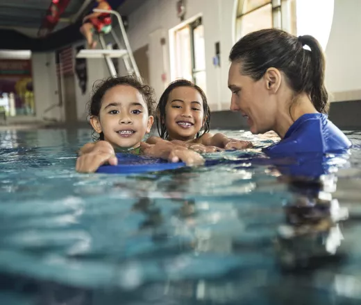 image of swim lesson inside a YMCA pool