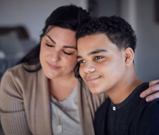 mother and son in home smiling warmly