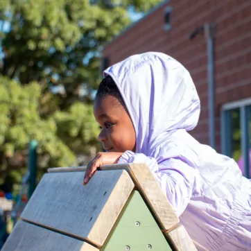 preschool student explores the Hilltop YMCA's Nature Playscape for the first time