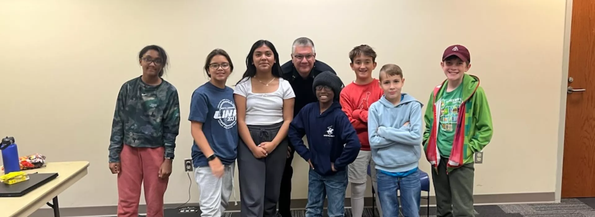 Teens posing with the chief of police